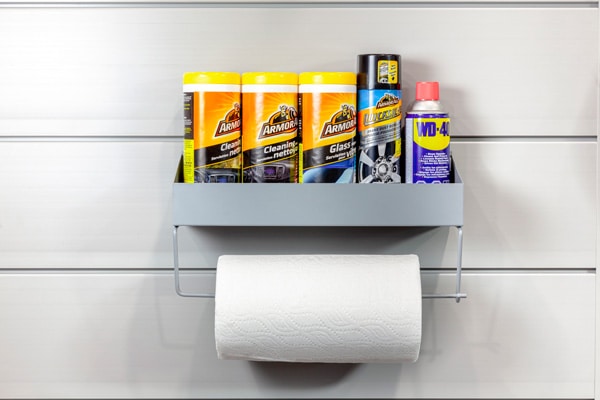 Paper Towel Rack. TOWELRK-V2. The perfect all-in-one supply station. The practical shelf accommodates a range of cleaning products, motor oil jugs and sprays. Mount a paper towel roll, rubban rolls, shop towels or various tapes on the dowel below.